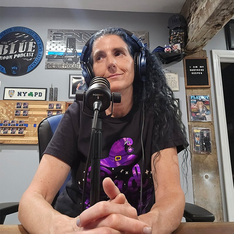 blue sitting in the chair with headphones on.